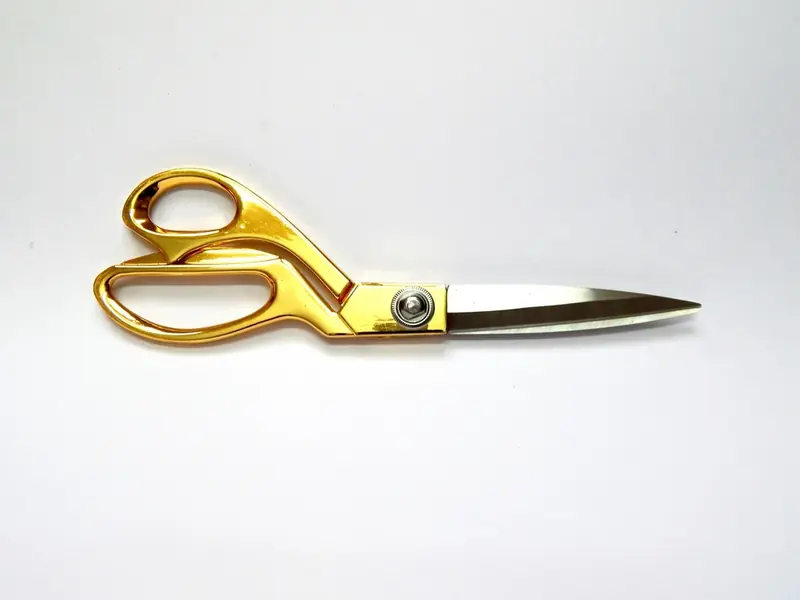 Gold tailoring scissors on fabric